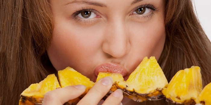 Девушка ест ананас для похудения